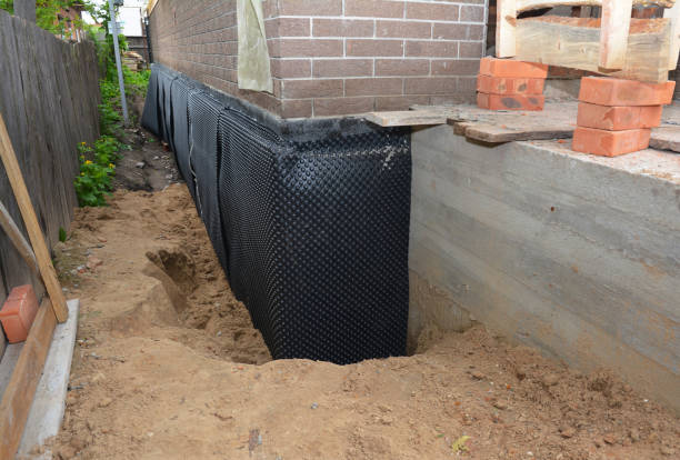 Happy homeowners after waterproofing job in Schneider
